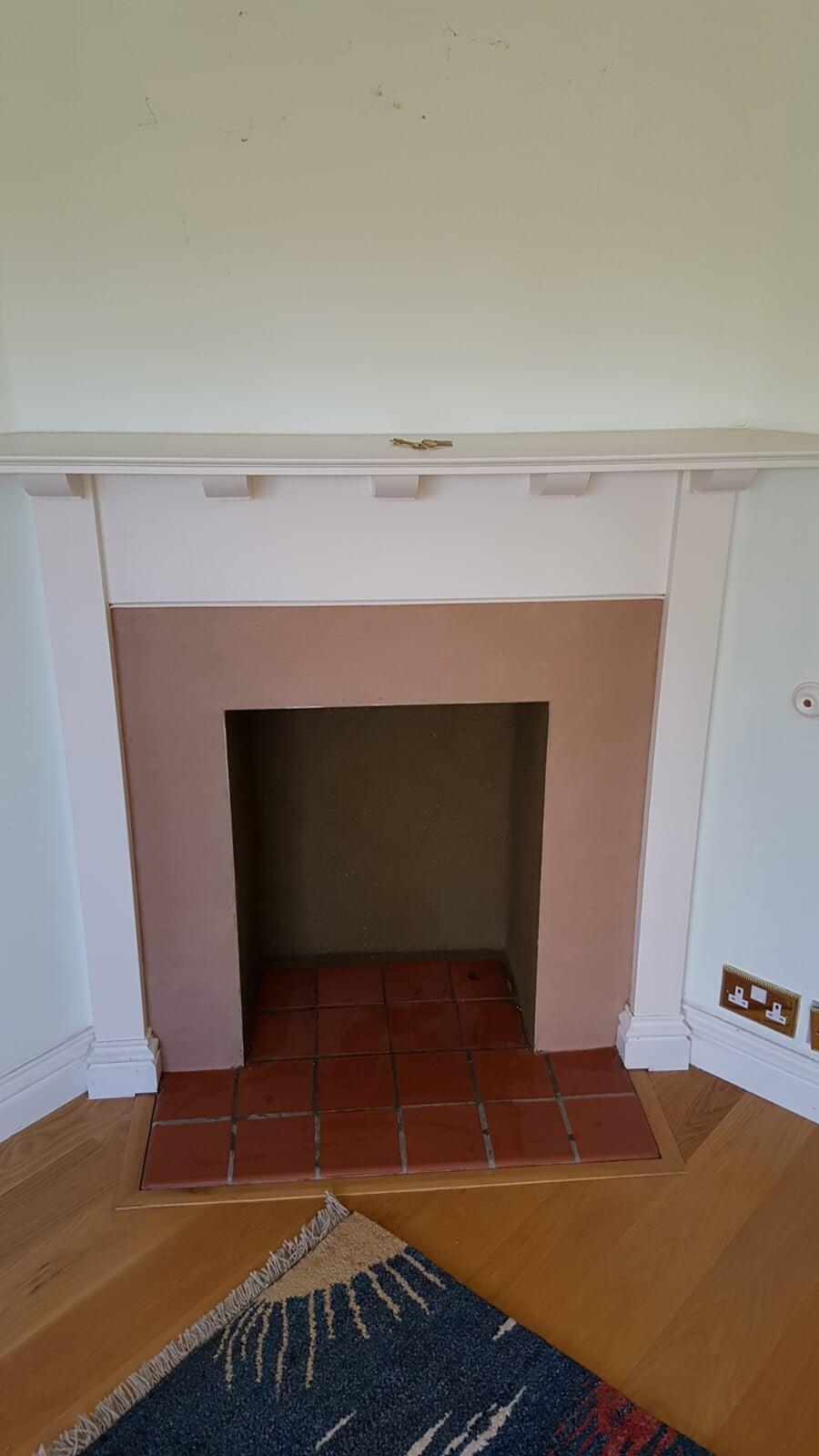 Tiled hearth with rendered fireplace chamber